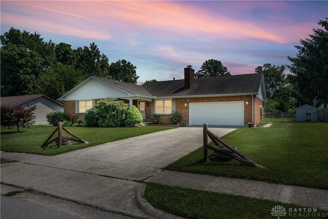 222 Alumni Cir, Wilmington, OH 45177 - ranch-style house featuring concrete driveway, brick siding, a chimney, and a garage