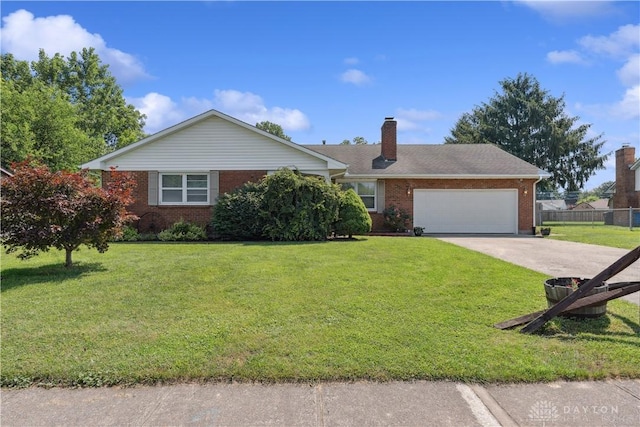 222 Alumni Cir, Wilmington, OH 45177 - ranch-style house with an attached garage, concrete driveway, brick siding, and a chimney
