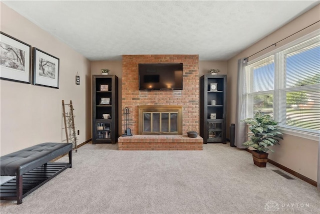 222 Alumni Cir, Wilmington, OH 45177 - living room featuring carpet flooring, a fireplace, and a textured ceiling