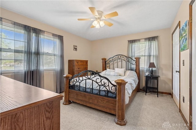 222 Alumni Cir, Wilmington, OH 45177 - bedroom featuring multiple windows, light carpet, and a ceiling fan