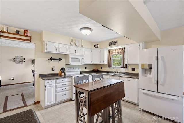 222 Alumni Cir, Wilmington, OH 45177 - kitchen featuring white appliances, dark countertops, white cabinetry, and light tile patterned flooring