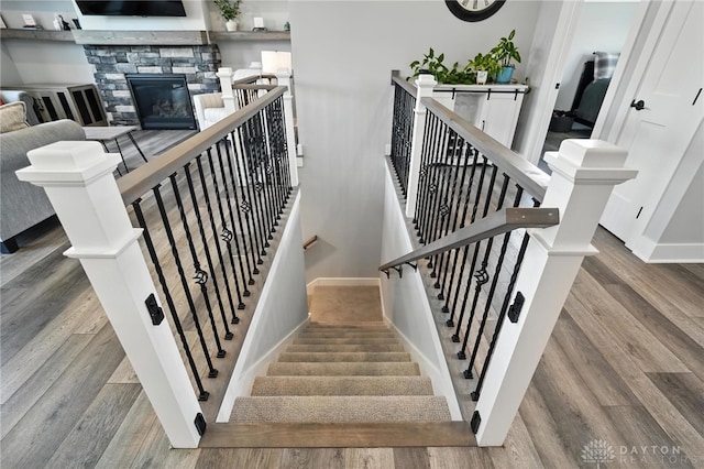 1471 Runnymeade Way, Beavercreek Twp, OH 45385 - stairway featuring wood finished floors and a stone fireplace