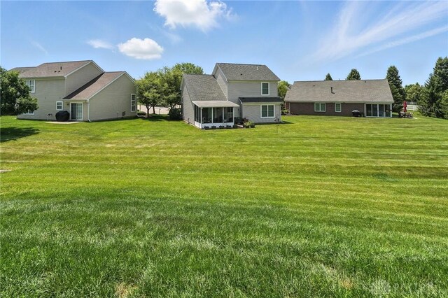 1471 Runnymeade Way, Beavercreek Twp, OH 45385 - view of grassy yard featuring a sunroom