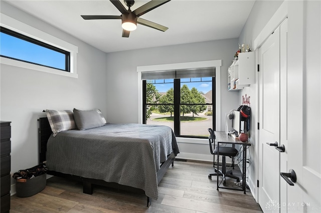 1471 Runnymeade Way, Beavercreek Twp, OH 45385 - bedroom with multiple windows, wood finished floors, and a ceiling fan