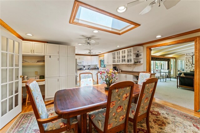 347 Winding Trl, Xenia, OH 45385 - dining space with a ceiling fan, a skylight, crown molding, recessed lighting, and light wood finished floors