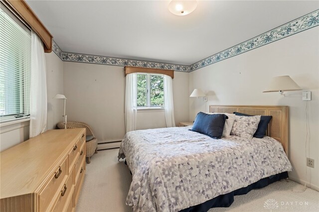 347 Winding Trl, Xenia, OH 45385 - bedroom featuring light carpet and a baseboard heating unit