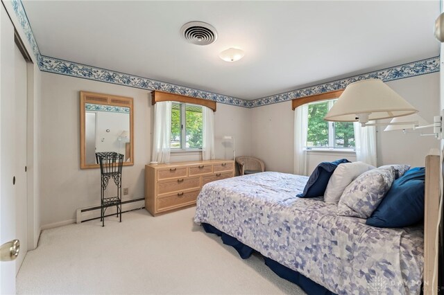 347 Winding Trl, Xenia, OH 45385 - carpeted bedroom featuring baseboard heating and multiple windows