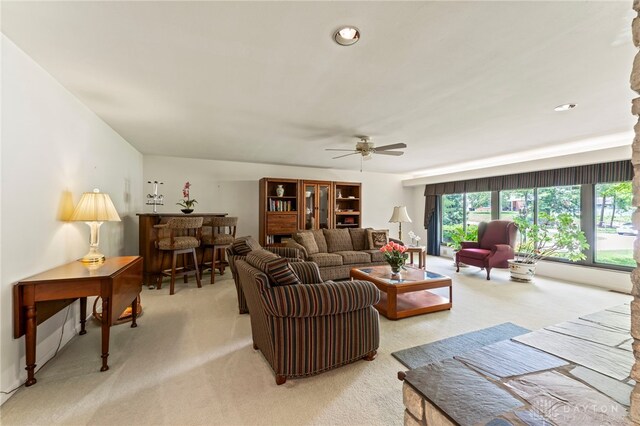 347 Winding Trl, Xenia, OH 45385 - living room featuring light colored carpet, a ceiling fan, a bar, and recessed lighting