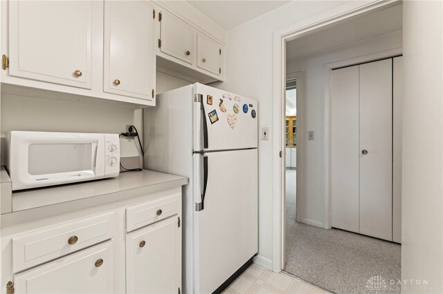 347 Winding Trl, Xenia, OH 45385 - kitchen featuring white appliances, light countertops, white cabinetry, and light flooring