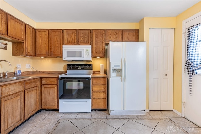 95 Marco Ln, Washington Twp, OH 45458 - kitchen featuring white appliances, brown cabinetry, and light tile patterned flooring