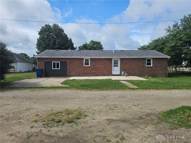 283 Moore St, Lewisburg, OH 45338 - view of front of property with brick siding, a front lawn, and dirt driveway