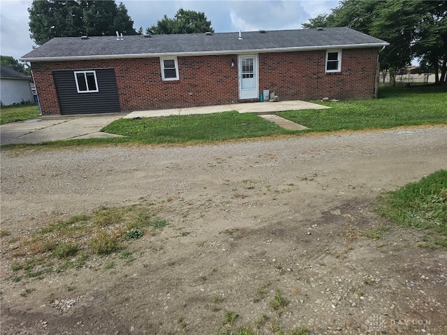 283 Moore St, Lewisburg, OH 45338 - view of front of property featuring brick siding, a front lawn, a patio, and a shingled roof