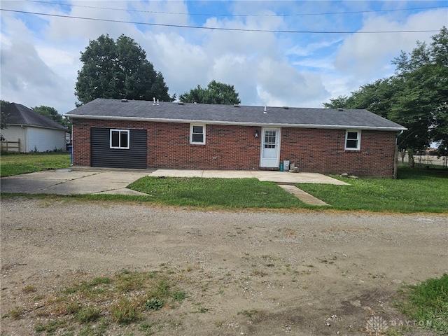 283 Moore St, Lewisburg, OH 45338 - view of front facade featuring brick siding, a patio, and a front lawn