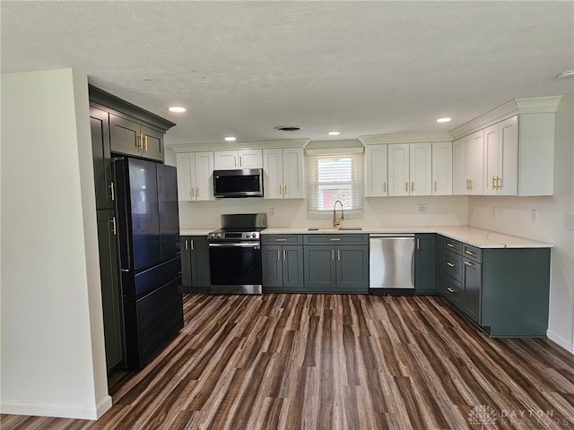 283 Moore St, Lewisburg, OH 45338 - kitchen featuring appliances with stainless steel finishes, dark wood-type flooring, light countertops, recessed lighting, and white cabinets
