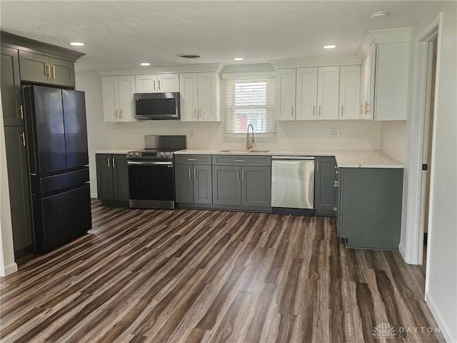 283 Moore St, Lewisburg, OH 45338 - kitchen with stainless steel appliances, dark wood-style floors, light countertops, white cabinets, and recessed lighting