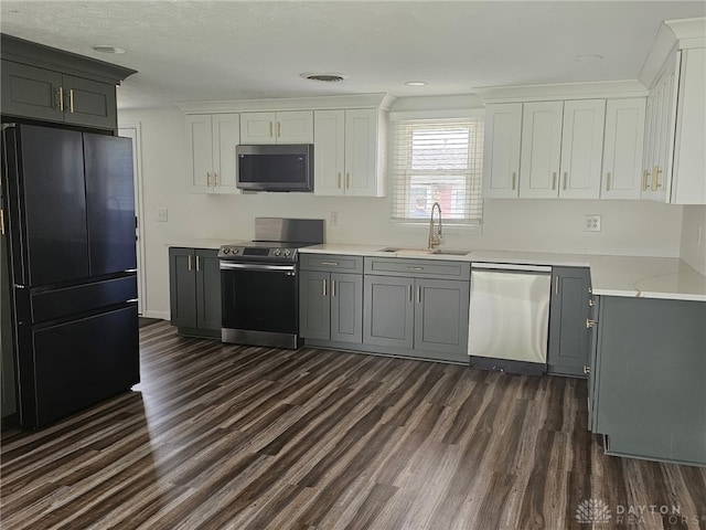 283 Moore St, Lewisburg, OH 45338 - kitchen with stainless steel appliances, dark wood-type flooring, white cabinetry, gray cabinets, and recessed lighting