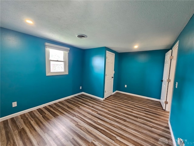 283 Moore St, Lewisburg, OH 45338 - unfurnished room featuring a textured ceiling, wood finished floors, and recessed lighting