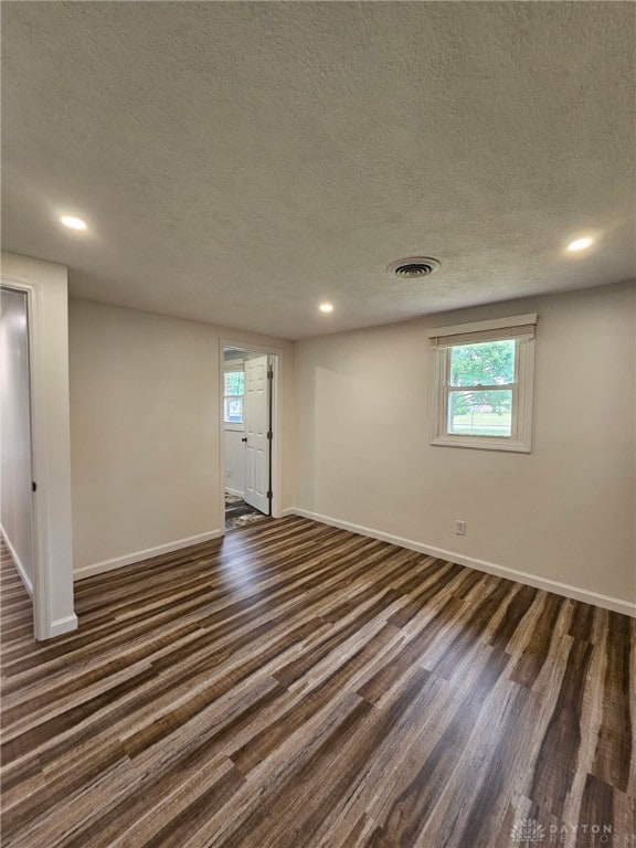 283 Moore St, Lewisburg, OH 45338 - empty room featuring dark wood finished floors, healthy amount of natural light, a textured ceiling, and recessed lighting