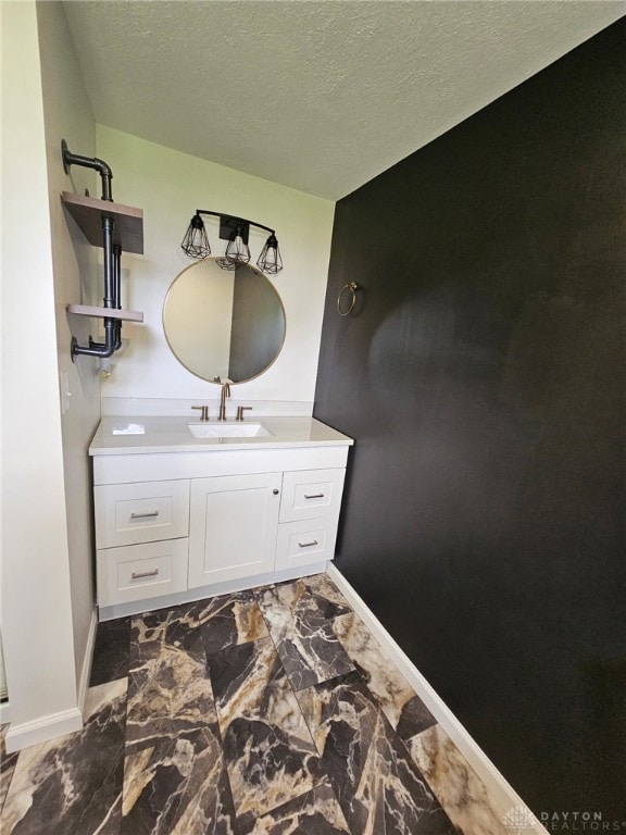 283 Moore St, Lewisburg, OH 45338 - bathroom with vanity, marble look tiles, and a textured ceiling