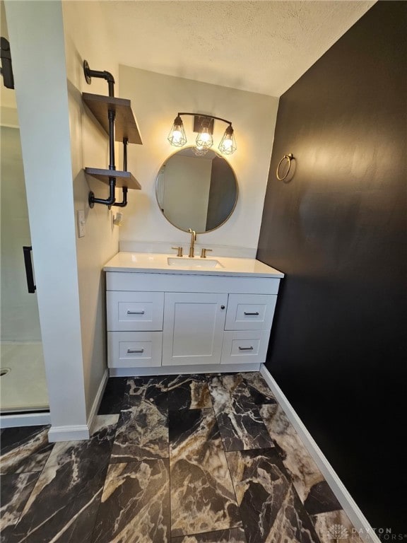 283 Moore St, Lewisburg, OH 45338 - bathroom with vanity, a textured ceiling, a stall shower, and marble finish flooring