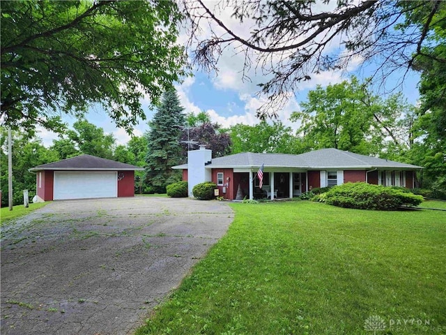 851 E County Line Rd, Springfield, OH 45502 - ranch-style home with a detached garage, a front lawn, an outdoor structure, and a chimney
