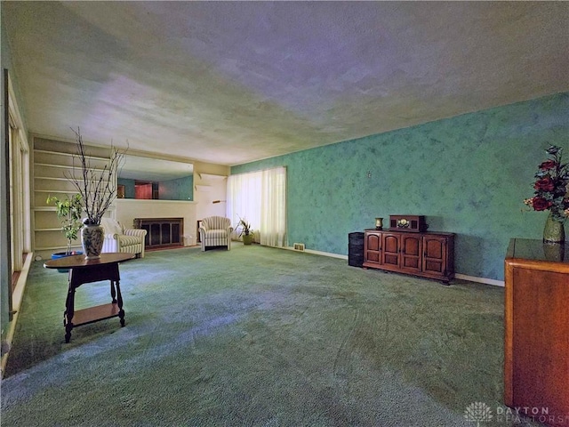 851 E County Line Rd, Springfield, OH 45502 - unfurnished living room featuring a glass covered fireplace and carpet