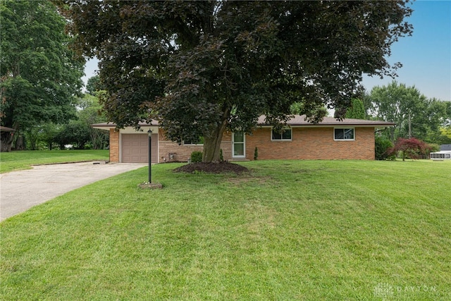 3442 Longleaf Ave, Beavercreek, OH 45430 - view of front of property with concrete driveway, a front yard, a garage, and brick siding