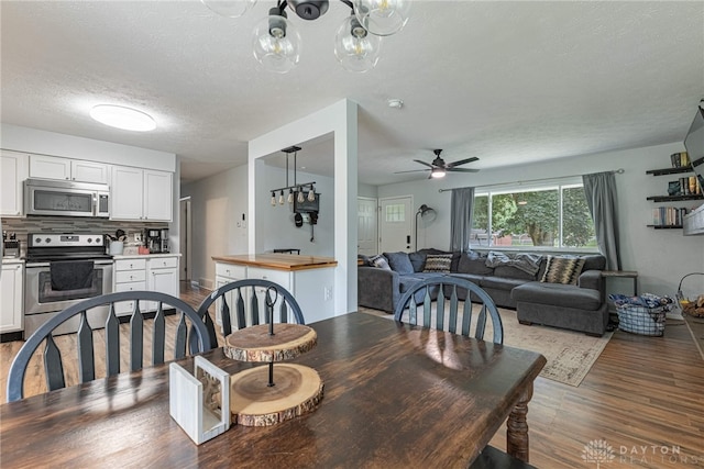 3442 Longleaf Ave, Beavercreek, OH 45430 - dining space with wood finished floors, a chandelier, ceiling fan, and a textured ceiling