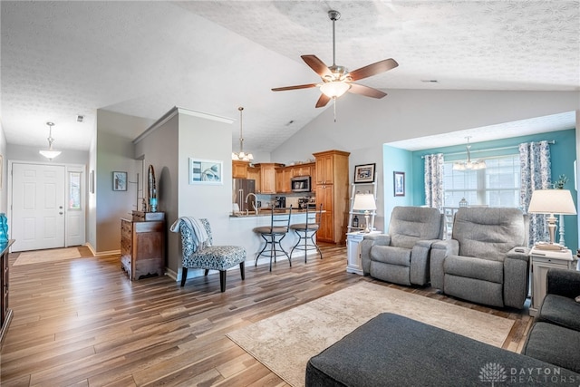488 Jodee Dr, Xenia, OH 45385 - living area featuring a chandelier, light wood-type flooring, ceiling fan, healthy amount of natural light, and a textured ceiling