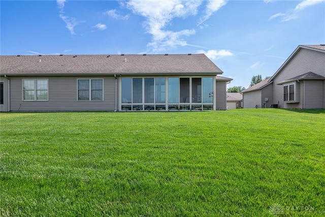 488 Jodee Dr, Xenia, OH 45385 - back of property with a lawn, a sunroom, and a shingled roof