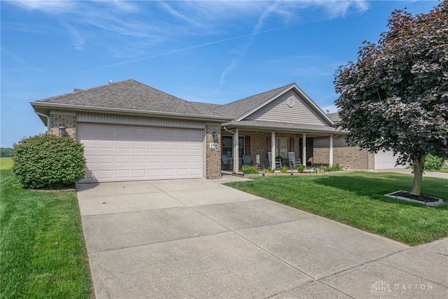 488 Jodee Dr, Xenia, OH 45385 - single story home with covered porch, an attached garage, a front lawn, concrete driveway, and brick siding