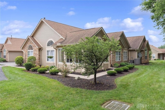 2782 Stefan Pl, Beavercreek, OH 45431 - view of front of property featuring roof with shingles, a front lawn, and stone siding