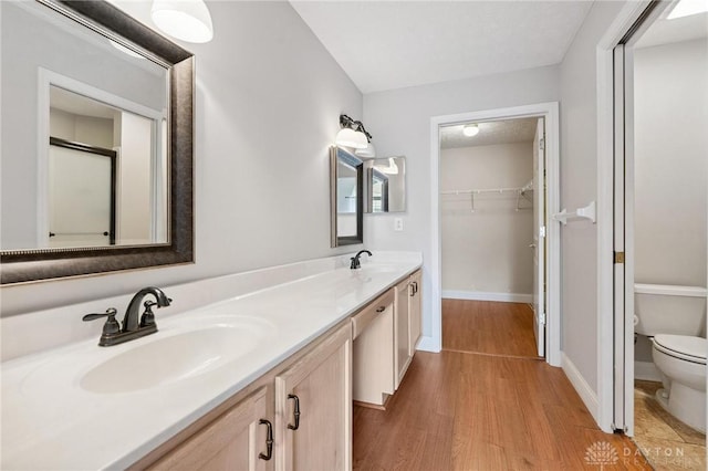 2782 Stefan Pl, Beavercreek, OH 45431 - full bathroom with double vanity, wood finished floors, and a spacious closet