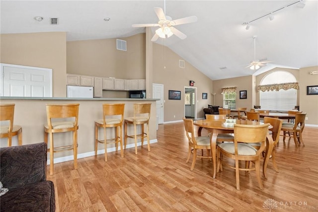 2782 Stefan Pl, Beavercreek, OH 45431 - dining area with ceiling fan, high vaulted ceiling, track lighting, and light wood-style flooring