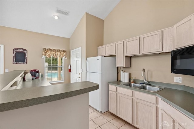 2782 Stefan Pl, Beavercreek, OH 45431 - kitchen with freestanding refrigerator, black microwave, high vaulted ceiling, light tile patterned floors, and dark countertops
