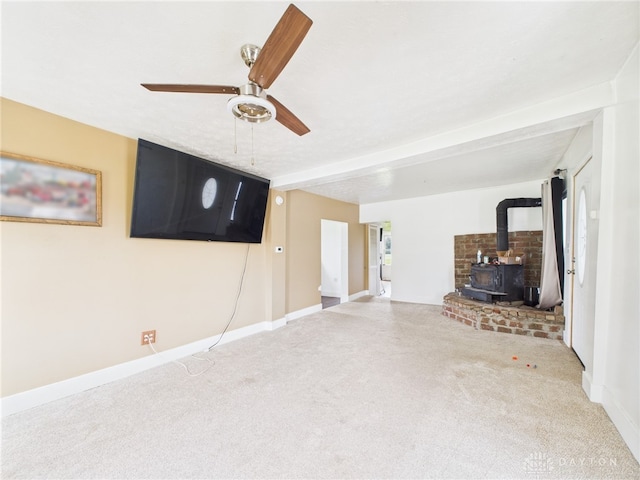 491 Frazers Rd, West Manchester, OH 45382 - unfurnished living room with a wood stove, a ceiling fan, and carpet
