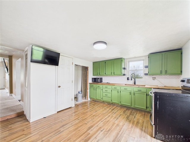 491 Frazers Rd, West Manchester, OH 45382 - kitchen featuring stainless steel appliances, green cabinetry, and light wood-style flooring