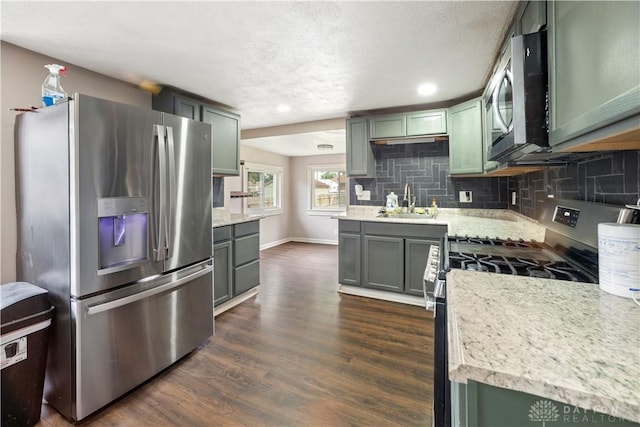 3579 Alberta St, Columbus, OH 43228 - kitchen featuring appliances with stainless steel finishes, dark wood-type flooring, backsplash, green cabinetry, and recessed lighting