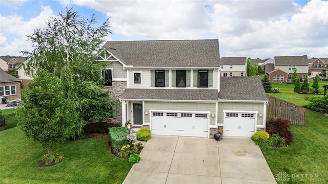 1950 Stone Creek Blvd, Clearcreek Twp, OH 45458 - view of front of property with driveway, stone siding, roof with shingles, and a residential view