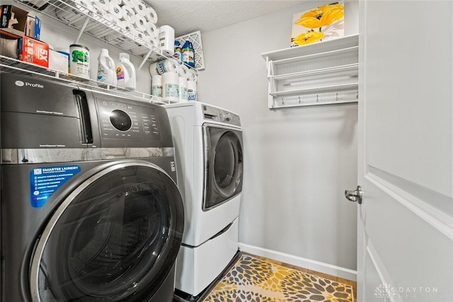 1950 Stone Creek Blvd, Clearcreek Twp, OH 45458 - laundry area with washing machine and clothes dryer and baseboards