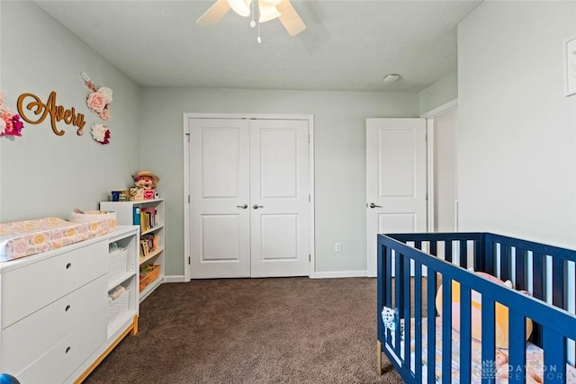 1950 Stone Creek Blvd, Clearcreek Twp, OH 45458 - bedroom with dark carpet, a crib, a closet, and ceiling fan