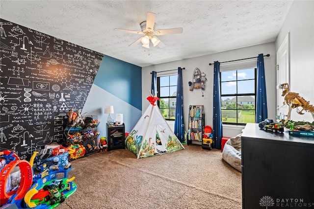 1950 Stone Creek Blvd, Clearcreek Twp, OH 45458 - playroom with carpet flooring, a ceiling fan, and a textured ceiling