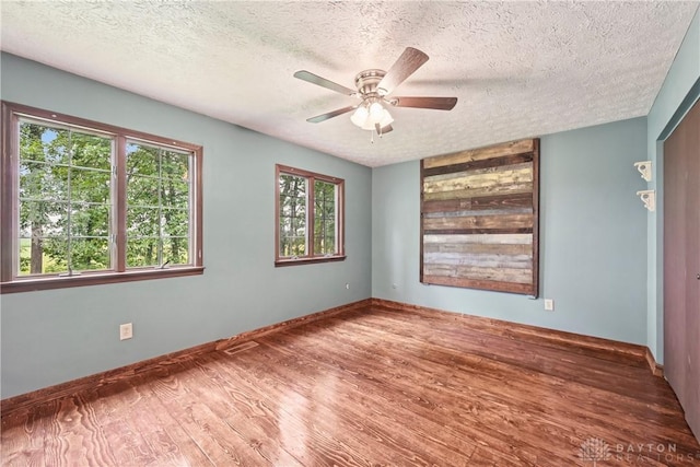 4595 Comanchee Trl, Silver Creek Twp, OH 45335 - unfurnished room with a textured ceiling, ceiling fan, and wood finished floors