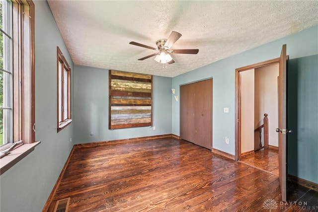4595 Comanchee Trl, Silver Creek Twp, OH 45335 - unfurnished bedroom with a textured ceiling, wood finished floors, and ceiling fan