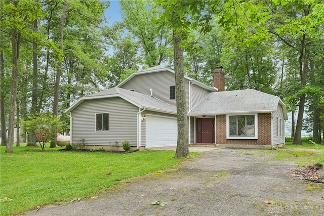 4595 Comanchee Trl, Silver Creek Twp, OH 45335 - view of front of home with a chimney, driveway, an attached garage, a front yard, and a shingled roof