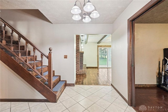 4595 Comanchee Trl, Silver Creek Twp, OH 45335 - tiled foyer with stairway, a chandelier, and a textured ceiling