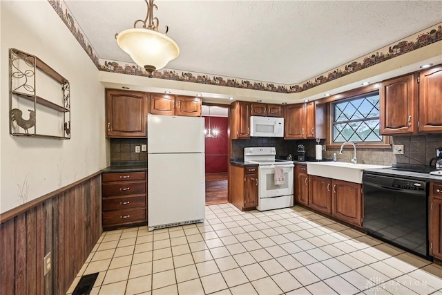 4595 Comanchee Trl, Silver Creek Twp, OH 45335 - kitchen featuring white appliances, tasteful backsplash, a wainscoted wall, and light tile patterned flooring