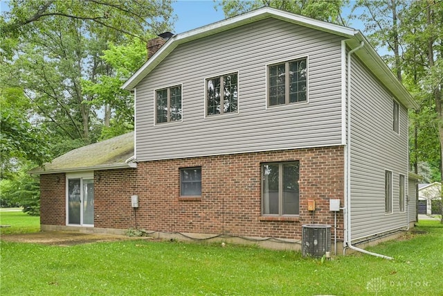 4595 Comanchee Trl, Silver Creek Twp, OH 45335 - rear view of property with a chimney, a yard, and brick siding