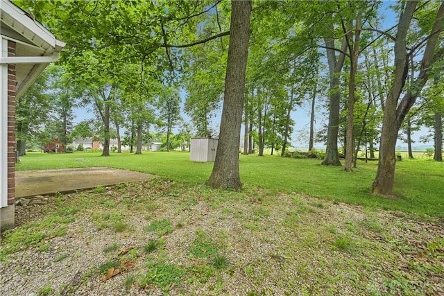 4595 Comanchee Trl, Silver Creek Twp, OH 45335 - view of grassy yard featuring a storage shed