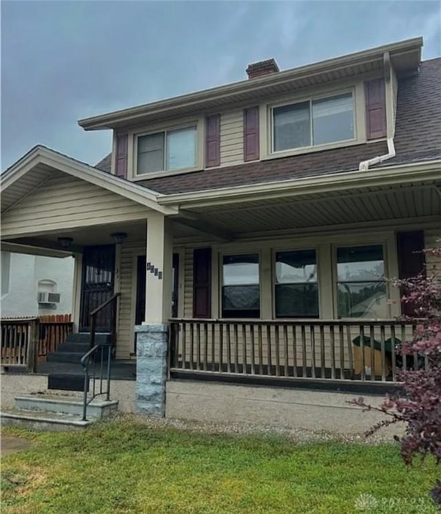 4009 E 3rd St, Dayton, OH 45403 - view of front of home featuring a porch, a chimney, and a shingled roof